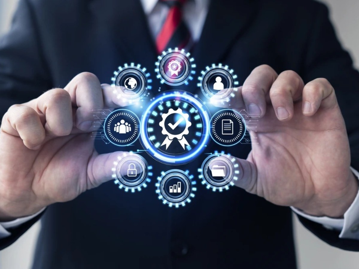 Quality assurance and certification icons over a pair of open hands