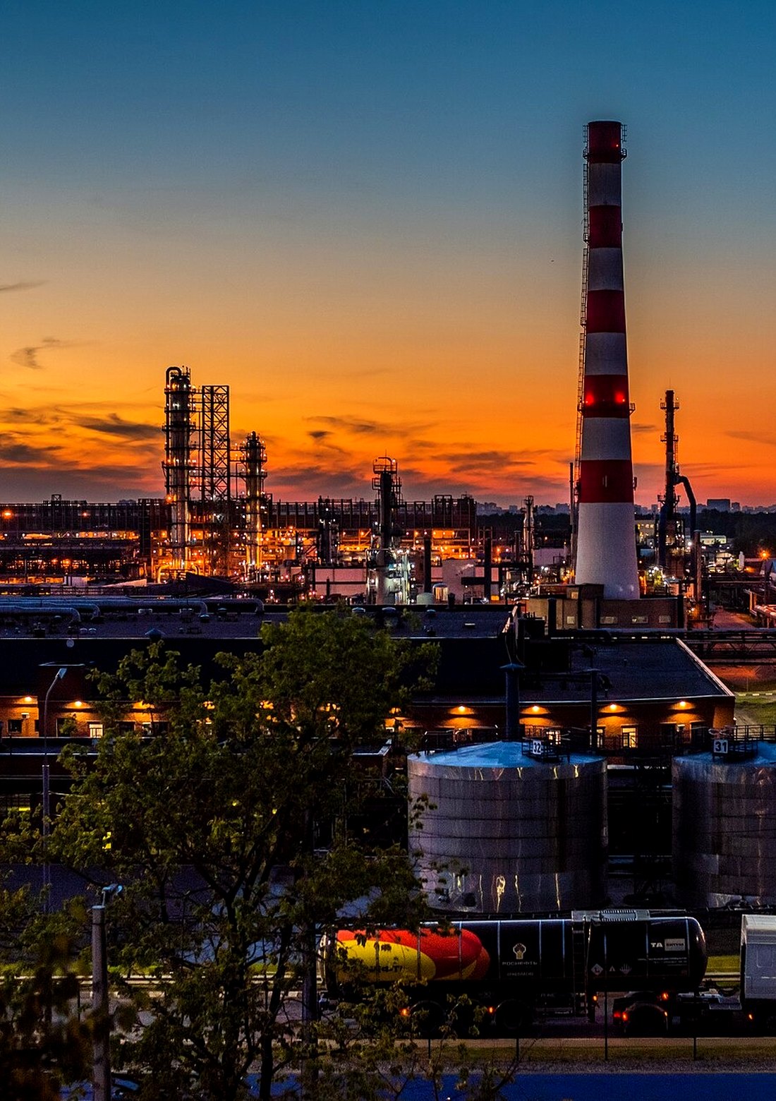 Refinery process units and stack at sunset